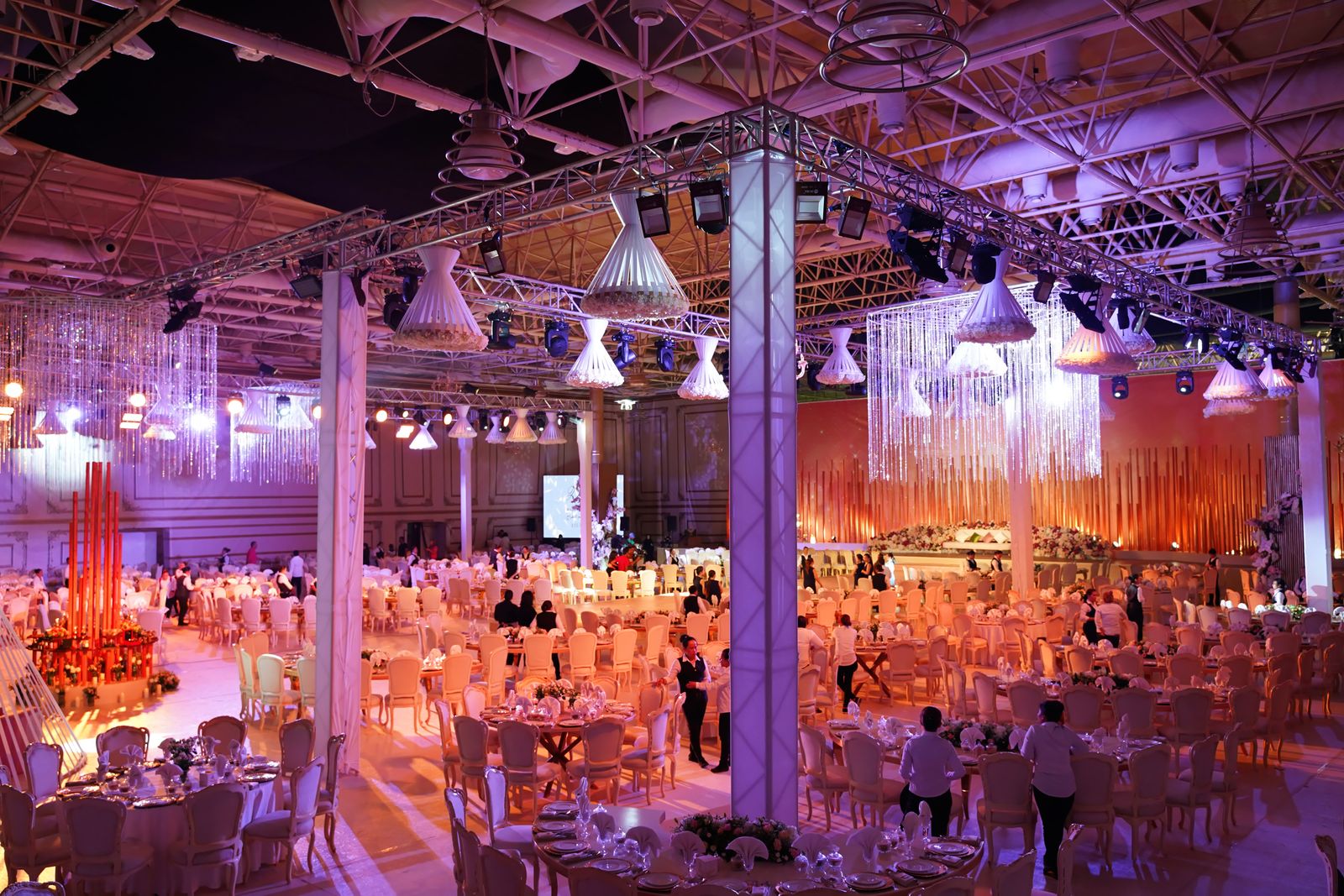 Guests gathering for an elegant gala in a warmly lit event hall